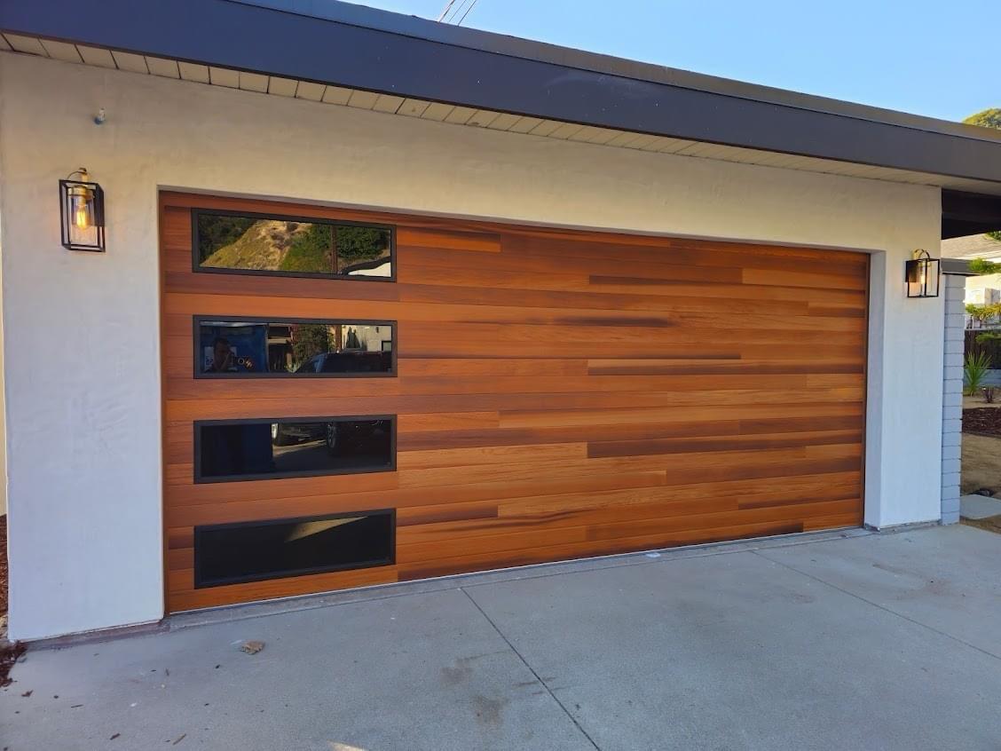 Modern horizontal cedar garage door with tinted windows