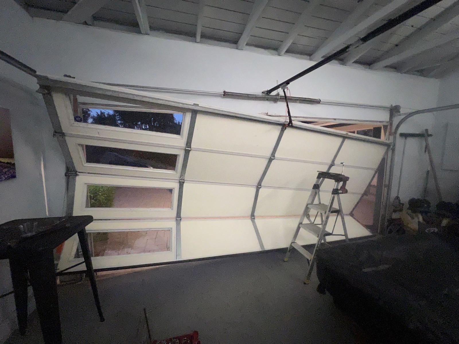 Garage door off track being repaired